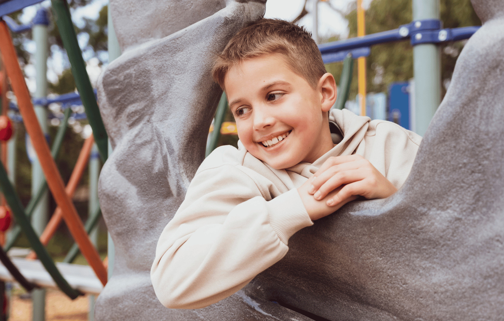 Boy playing on playground equipment