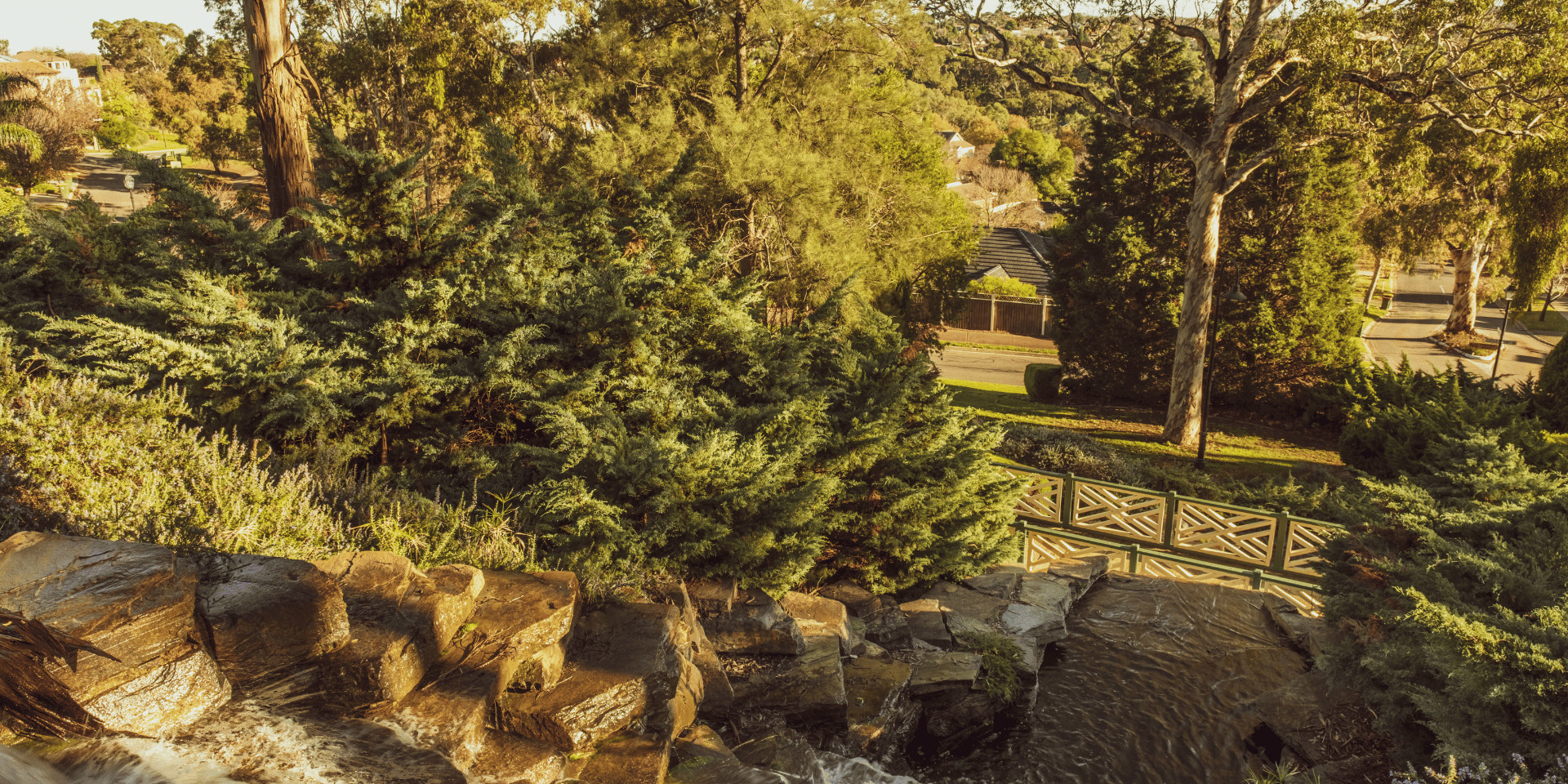 Landscaped gardens with a waterfall and a footbridge