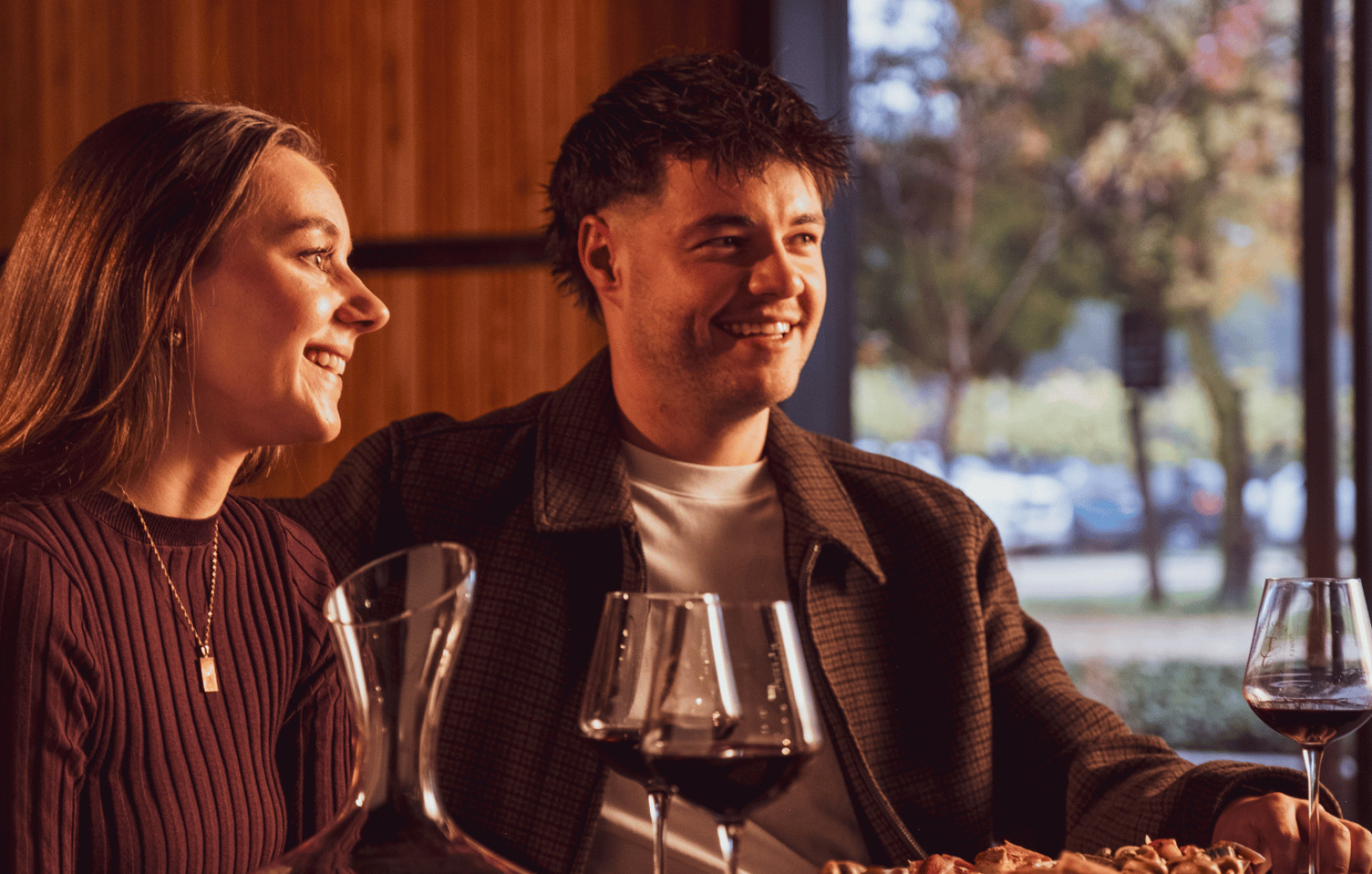 Couple with glasses of red wine at a winery
