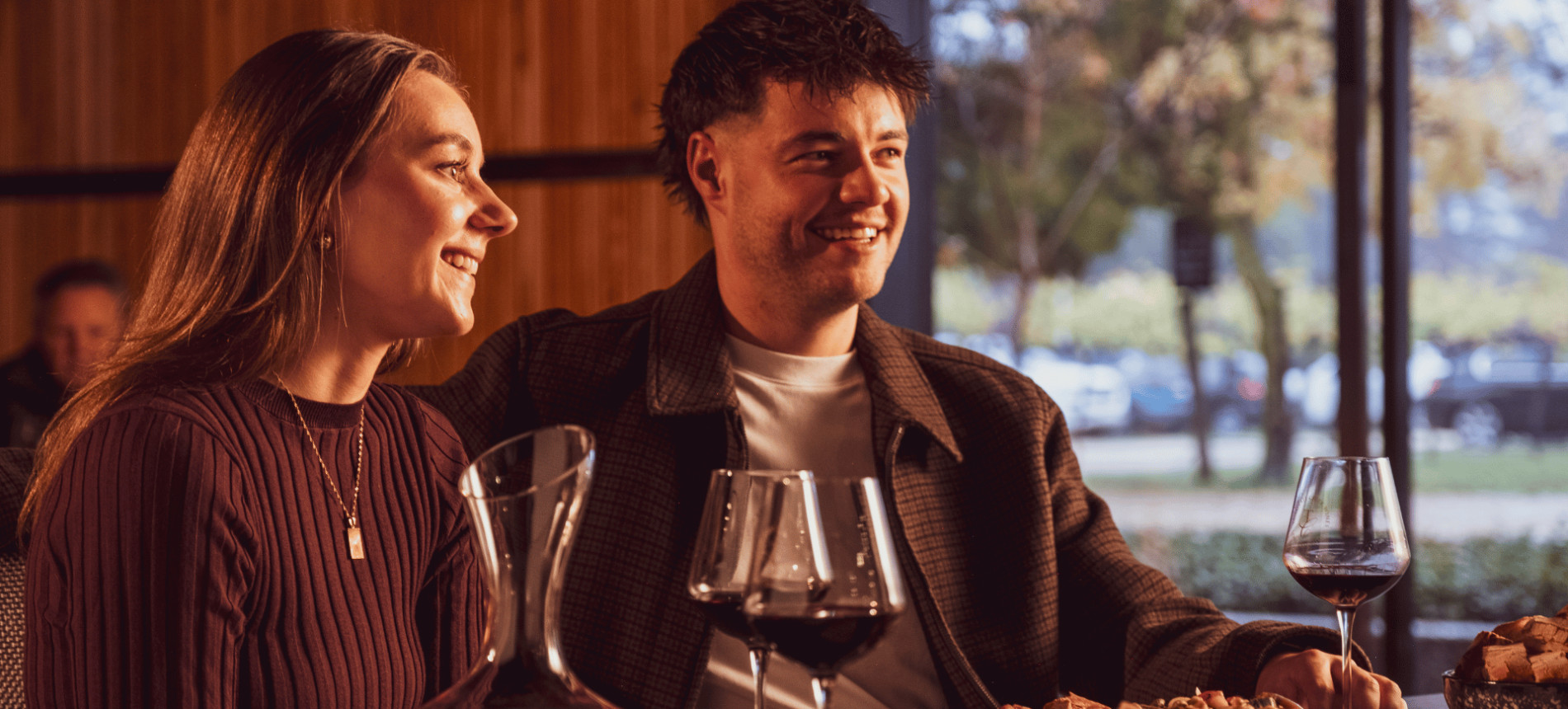Couple with glasses of red wine at a winery